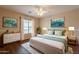 Stylishly furnished main bedroom with natural light and wood-look floors and neutral walls at 33055 N Madison Way Dr, San Tan Valley, AZ 85144