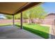 Covered patio overlooking a green lawn and a brick privacy wall, offering a relaxing outdoor space at 33055 N Madison Way Dr, San Tan Valley, AZ 85144