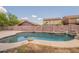 Pool in backyard, fenced in for safety, with rock features, surrounded by lush landscaping at 33055 N Madison Way Dr, San Tan Valley, AZ 85144