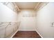 Empty walk-in closet with wire shelving and wood-look flooring, offering ample storage at 33055 N Madison Way Dr, San Tan Valley, AZ 85144