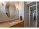 Bathroom vanity with a marble countertop, round mirror, and updated fixtures at 3600 N 5Th Ave # 302, Phoenix, AZ 85013
