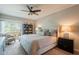 Bedroom boasts a ceiling fan, large bed, and a sliding glass door leading to a balcony at 3600 N 5Th Ave # 302, Phoenix, AZ 85013