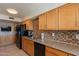 Modern kitchen with stainless steel appliances, granite countertops, and natural wood cabinetry at 3600 N 5Th Ave # 302, Phoenix, AZ 85013