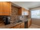 Well-equipped kitchen featuring granite countertops, wood cabinets, and stainless steel appliances at 3600 N 5Th Ave # 302, Phoenix, AZ 85013