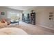 Stylish living area with large TV and shelving, leading to a balcony with natural light at 3600 N 5Th Ave # 302, Phoenix, AZ 85013