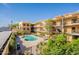 Exterior view of a community pool surrounded by lush greenery and well-maintained building at 3600 N 5Th Ave # 302, Phoenix, AZ 85013