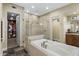 Large bathroom featuring a soaking tub, glass shower, and dual vanities at 36389 N 105Th Pl, Scottsdale, AZ 85262