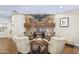 Inviting living room showcases a stone fireplace, hardwood floors, and elegant decor, creating a warm ambiance at 36389 N 105Th Pl, Scottsdale, AZ 85262