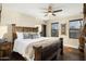 Cozy bedroom with a rustic wooden bed frame and view of the desert landscape at 36389 N 105Th Pl, Scottsdale, AZ 85262