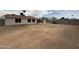 Wide shot of the backyard, showing the block fence and patio cover at 3749 W Gelding Dr, Phoenix, AZ 85053