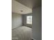 Carpeted bedroom features neutral walls, modern lighting, and a street view from the window at 3749 W Gelding Dr, Phoenix, AZ 85053