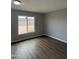 Bedroom with modern wood flooring, neutral walls, and a bright window at 3749 W Gelding Dr, Phoenix, AZ 85053