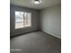 Bedroom with neutral walls, carpet flooring, and a window with an exterior view at 3749 W Gelding Dr, Phoenix, AZ 85053