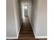 Hallway with neutral walls and modern wood-look flooring leading to other rooms at 3749 W Gelding Dr, Phoenix, AZ 85053
