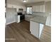 Bright kitchen features stainless steel appliances, white cabinets and granite countertops at 3749 W Gelding Dr, Phoenix, AZ 85053