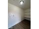 Laundry room with shelving, washer hookups, and modern wood look flooring at 3749 W Gelding Dr, Phoenix, AZ 85053