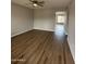 Open living room features modern wood flooring, neutral walls and ceiling fan light fixture at 3749 W Gelding Dr, Phoenix, AZ 85053