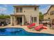 Inviting backyard featuring a sparkling pool and comfortable lounge chairs at 40345 W Molly Ln, Maricopa, AZ 85138