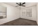Well-lit bedroom featuring plush carpet, neutral walls, and a modern ceiling fan at 40345 W Molly Ln, Maricopa, AZ 85138