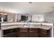 Kitchen featuring a large sink and backsplash with a view of the open floorplan of the living space at 40345 W Molly Ln, Maricopa, AZ 85138