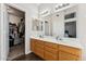 Bathroom boasts dual sinks, wood cabinets, and a walk-in closet for ample storage at 4314 E Anderson Dr, Phoenix, AZ 85032