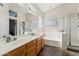 Bright bathroom with dual sinks, soaking tub, and glass enclosed shower with tile floors at 4314 E Anderson Dr, Phoenix, AZ 85032