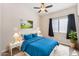 Bright bedroom showcases a bed, nightstands with lamps, a ceiling fan, and window with curtains at 4314 E Anderson Dr, Phoenix, AZ 85032