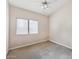 Carpeted bedroom is complete with a ceiling fan and a window to let in natural light at 4314 E Anderson Dr, Phoenix, AZ 85032