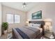 Staged bedroom has a ceiling fan, and a window allowing for bright natural light at 4314 E Anderson Dr, Phoenix, AZ 85032