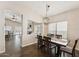 Bright dining area open to living area, offering stylish pendant lighting above table at 4314 E Anderson Dr, Phoenix, AZ 85032