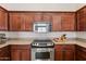 This is a spacious kitchen with stainless steel appliances, granite countertops, and wooden cabinets at 4314 E Anderson Dr, Phoenix, AZ 85032