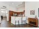 Kitchen bar with seating adjacent to living area, providing an inclusive design at 4314 E Anderson Dr, Phoenix, AZ 85032