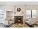 Bright living room featuring a cozy fireplace, tile floors, and neutral paint at 4314 E Anderson Dr, Phoenix, AZ 85032
