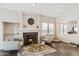 Bright living room featuring a cozy fireplace, tile floors, and neutral paint at 4314 E Anderson Dr, Phoenix, AZ 85032