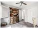 Spare bedroom featuring a vintage cabinet, soft carpet, closet space, and natural light at 44976 W Miramar Rd, Maricopa, AZ 85139