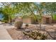 Charming single-story home with a two-car garage, drought-tolerant landscaping, and mature shade trees at 44976 W Miramar Rd, Maricopa, AZ 85139