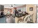Open kitchen featuring granite countertops, modern stainless appliances, and seating at the breakfast bar at 44976 W Miramar Rd, Maricopa, AZ 85139