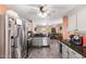 Modern kitchen featuring stainless steel appliances, granite countertops, and open layout to living area at 44976 W Miramar Rd, Maricopa, AZ 85139
