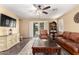 Comfortable living room with tile floors, ceiling fan, and access to the backyard at 44976 W Miramar Rd, Maricopa, AZ 85139