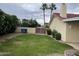 Backyard features a large lawn area, privacy wall, and mature trees at 4801 E Sheena Dr, Scottsdale, AZ 85254