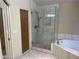 Bright bathroom with modern glass shower and soaking tub, offering a spa-like experience at 4801 E Sheena Dr, Scottsdale, AZ 85254