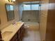 Well-lit bathroom with double vanity, quartz countertops, and luxurious tiled shower at 4801 E Sheena Dr, Scottsdale, AZ 85254