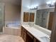 Spacious bathroom featuring double sinks, large soaking tub, and walk-in glass shower at 4801 E Sheena Dr, Scottsdale, AZ 85254