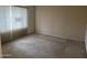 Neutral bedroom featuring a large window with blinds and neutral carpeting at 4801 E Sheena Dr, Scottsdale, AZ 85254