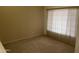 Neutral bedroom featuring a large window with blinds and neutral carpeting at 4801 E Sheena Dr, Scottsdale, AZ 85254