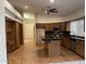 Eat-in kitchen features wood cabinets, an island with seating, a ceiling fan, and wood flooring at 4801 E Sheena Dr, Scottsdale, AZ 85254