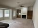 Bright living room with a fireplace, wet bar, built-in shelving and large windows at 4801 E Sheena Dr, Scottsdale, AZ 85254
