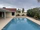 Backyard swimming pool with a tan concrete deck, block wall and patio at 4801 E Sheena Dr, Scottsdale, AZ 85254