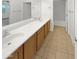 Bright bathroom with double sinks, a large mirror, and tiled floors connecting to the bedroom at 5140 W Bent Tree Dr, Phoenix, AZ 85083