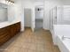 Bathroom featuring tile flooring, double sink vanity, bathtub, and shower at 5140 W Bent Tree Dr, Phoenix, AZ 85083